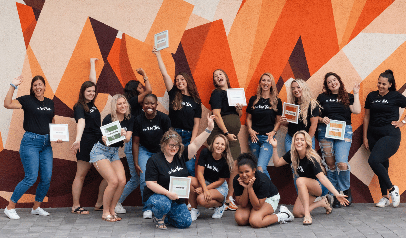 Large group of women posing together, empowerment event and community gathering
